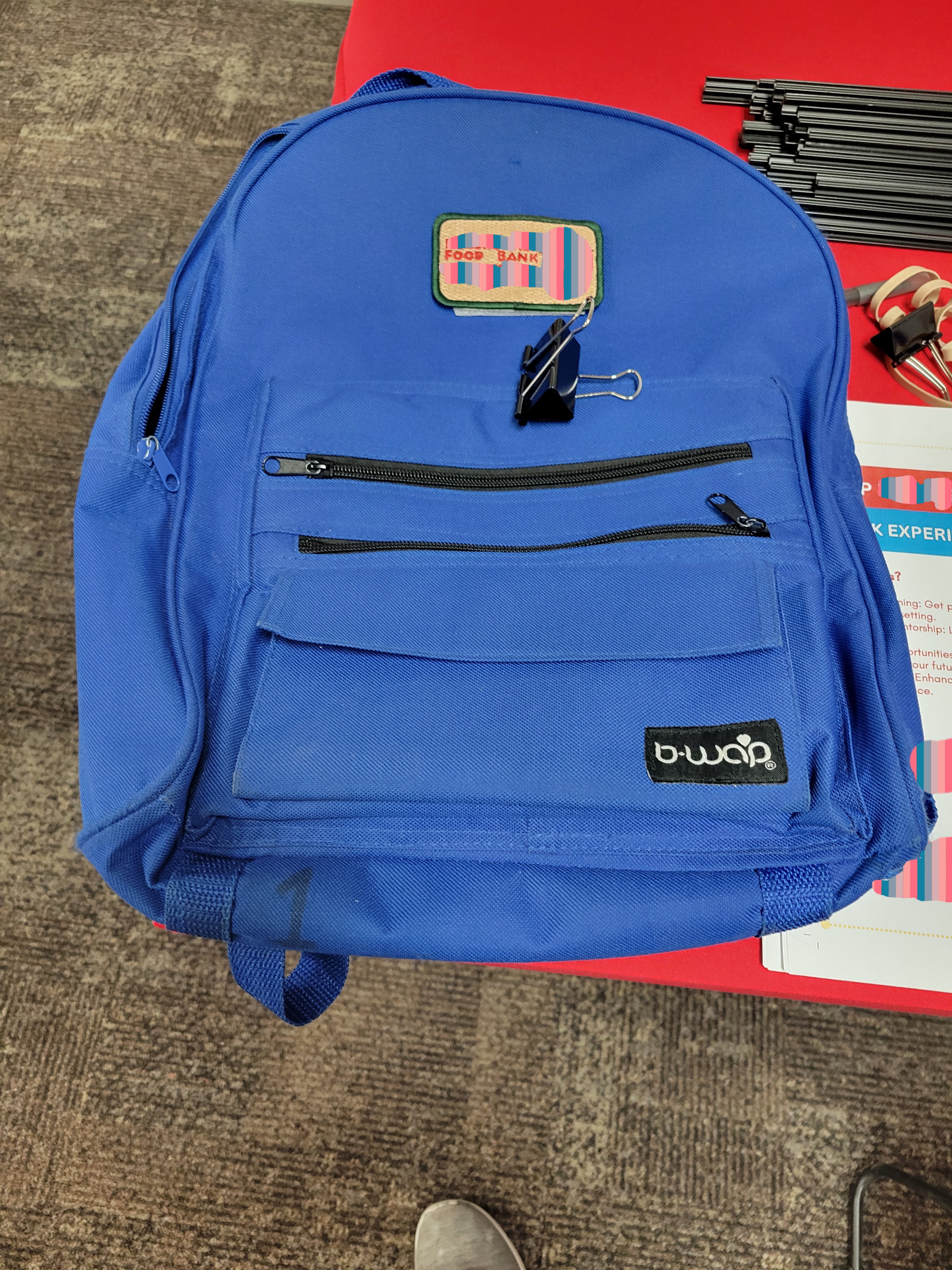 Blue backpack with the food bank logo on it.